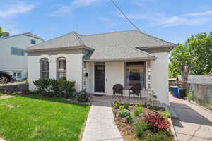 View of front facade featuring stucco siding and covered porch