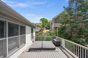 Deck featuring a covered hot tub