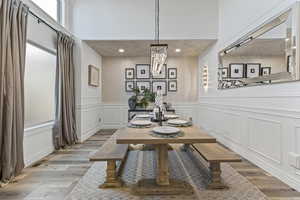 Dining space with wood finished floors, recessed lighting, and a chandelier