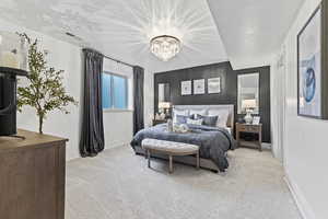 Bedroom featuring light colored carpet, a chandelier, and an accent wall
