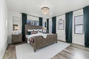 Bedroom with a chandelier and light wood-style flooring