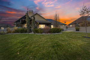 Back of property featuring stucco siding, a chimney, and solar panels