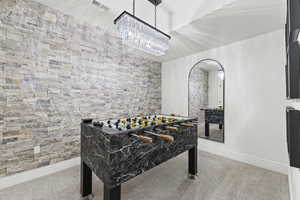 Rec room featuring light colored carpet and arched walkways