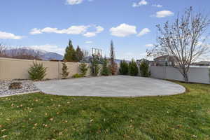 View of basketball court featuring a fenced backyard, basketball court, and a mountain view
