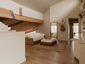 Living room featuring high vaulted ceiling and light wood finished floors