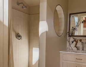 Full bathroom with vanity and a tile shower