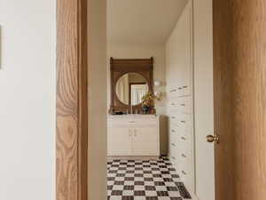 Half bath with vanity and light floors