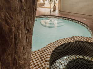 View of swimming pool with a jacuzzi