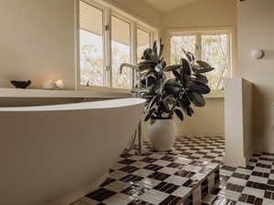 Bathroom view of a freestanding tub and baseboards
