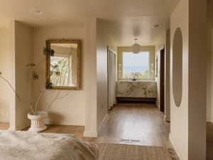 Hall featuring light wood finished floors and baseboards