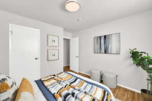 Spacious bedroom with wood floors and a large closet