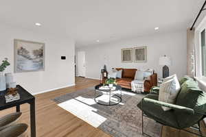 Living area featuring recessed lighting and well-maintained, original  wood flooring