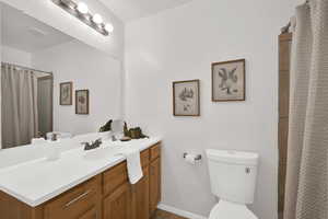 Full bath featuring a shower with shower curtain and vanity