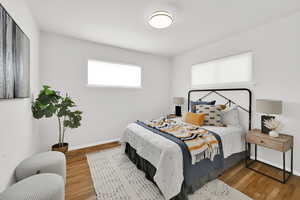 Spacious bedroom with wood floors