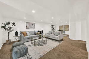 Large basement living area with recessed lighting and carpet flooring