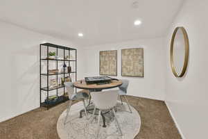 Large basement living area with recessed lighting and carpet flooring