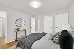 Primary bedroom with 2 closet doors and an en-suite full bath