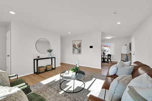Living area featuring recessed lighting and well-maintained, original  wood flooring