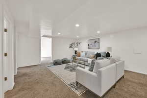 Large basement living area with recessed lighting and carpet flooring