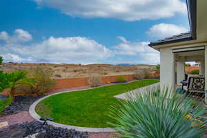 Fenced backyard featuring a mountain view