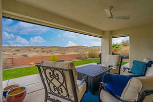 Fenced backyard with a patio area and ceiling fan