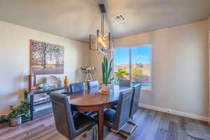 Dining room with a chandelier and wood finished floors