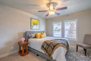 Bedroom featuring carpet, a ceiling fan, and a textured ceiling