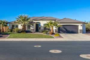 View of front of home featuring stucco siding, concrete driveway, a garage, and a tile roof