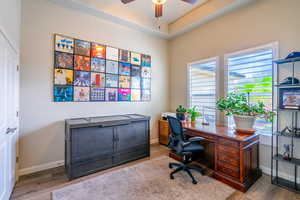 Office space with a ceiling fan and wood finished floors