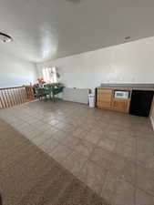 Dining room with light tile patterned floors and a textured ceiling