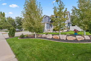 View of front of house featuring a front lawn and a garage
