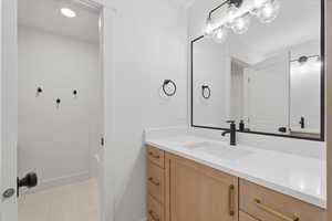 Bathroom featuring vanity, recessed lighting, and light tile patterned floors
