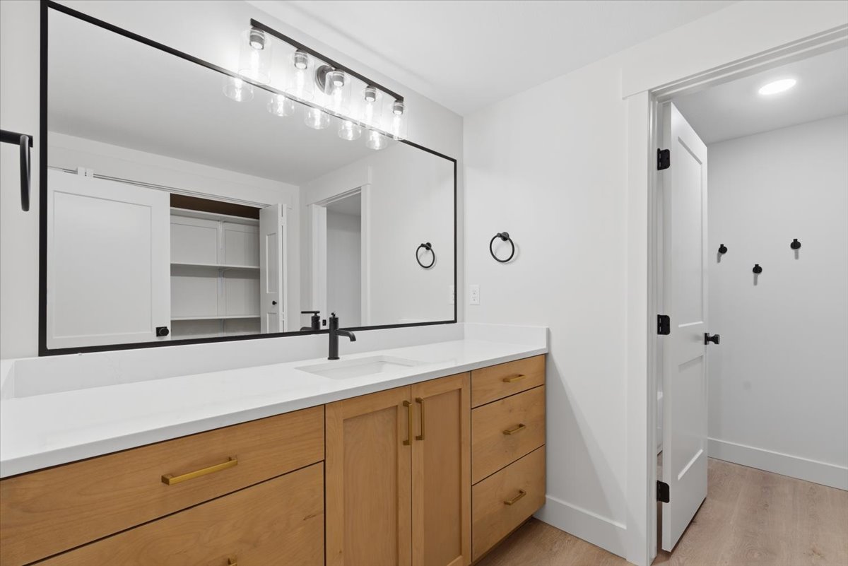 Bathroom with vanity, light wood-type flooring, and recessed lighting
