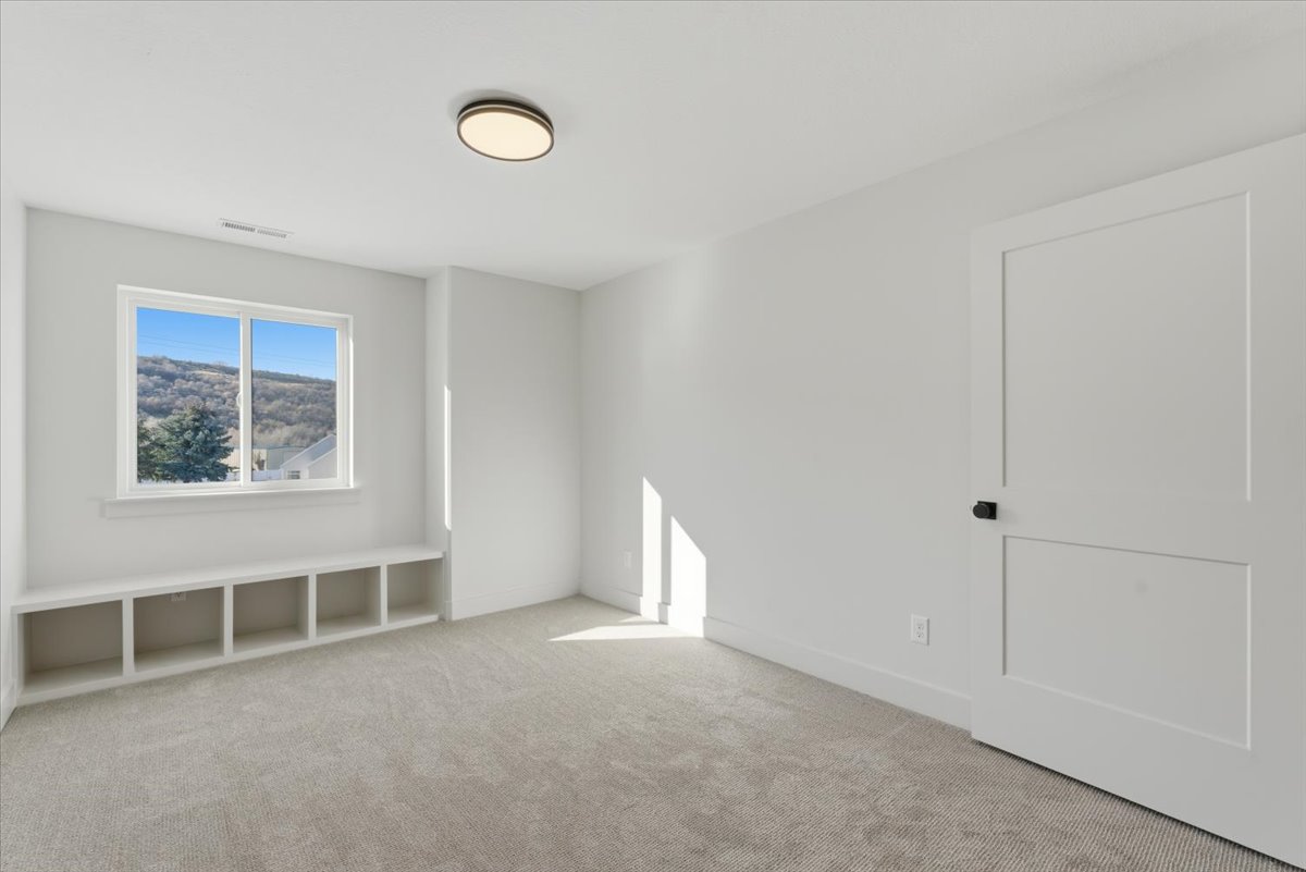 Unfurnished room with light colored carpet
