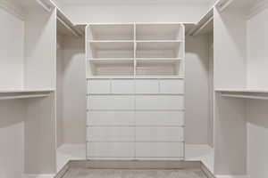 Walk in closet with light carpet