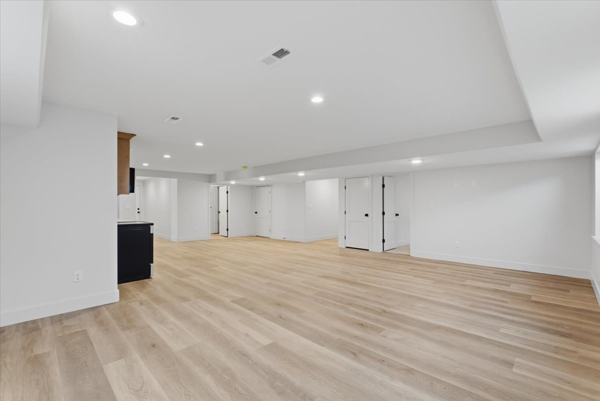 Finished below grade area featuring recessed lighting and light wood finished floors