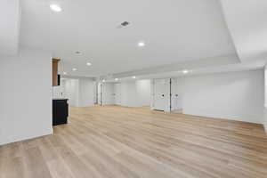 Finished below grade area featuring recessed lighting and light wood finished floors