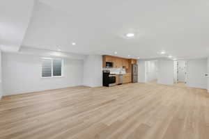 Unfurnished living room with light wood-style floors and recessed lighting