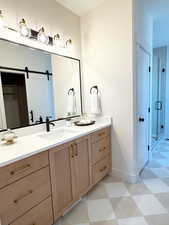 Bathroom featuring vanity, a shower stall, and light flooring