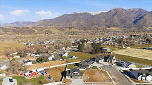 Aerial view of property's location featuring nearby suburban area and a mountainous background