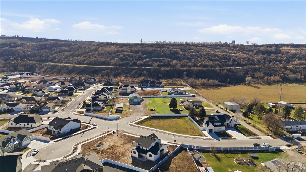 Aerial view of property and surrounding area with nearby suburban area
