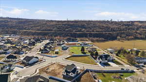 Aerial view of property and surrounding area with nearby suburban area