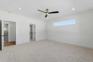 Unfurnished bedroom with ceiling fan, light colored carpet, and recessed lighting