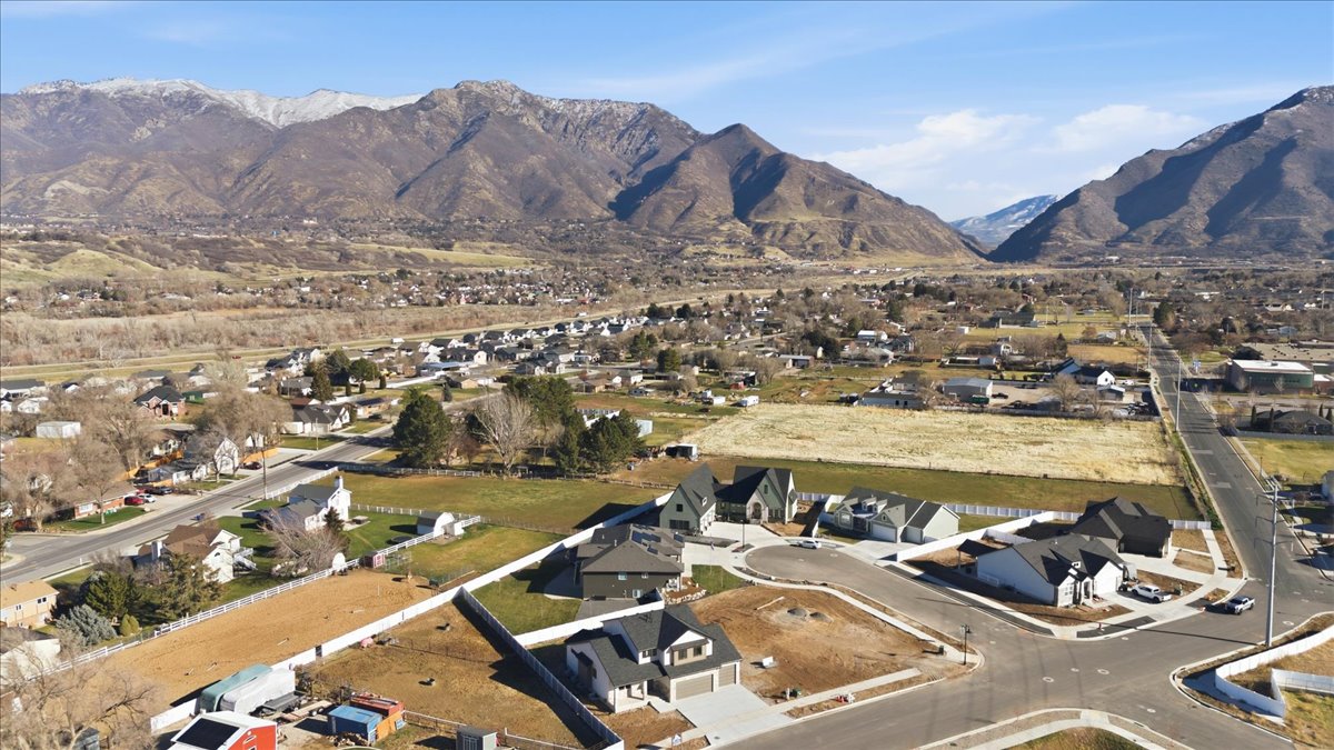 Aerial overview of property's location featuring nearby suburban area and a mountainous background