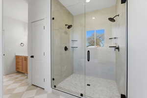 Full bathroom with vanity, a stall shower, and light flooring