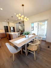 Dining space featuring dark wood finished floors and recessed lighting