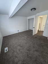 Bonus room with dark carpet