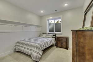 Bedroom featuring baseboards and light carpet