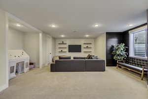 Living room featuring light colored carpet and recessed lighting