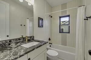 Bathroom featuring shower / bath combo and vanity